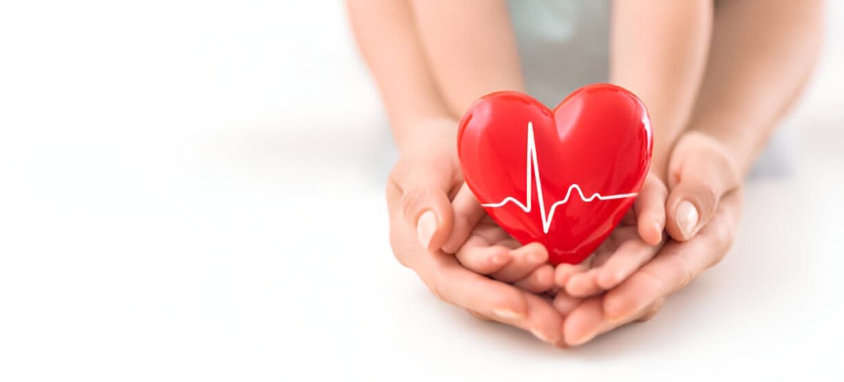 Child and adult holding heart together