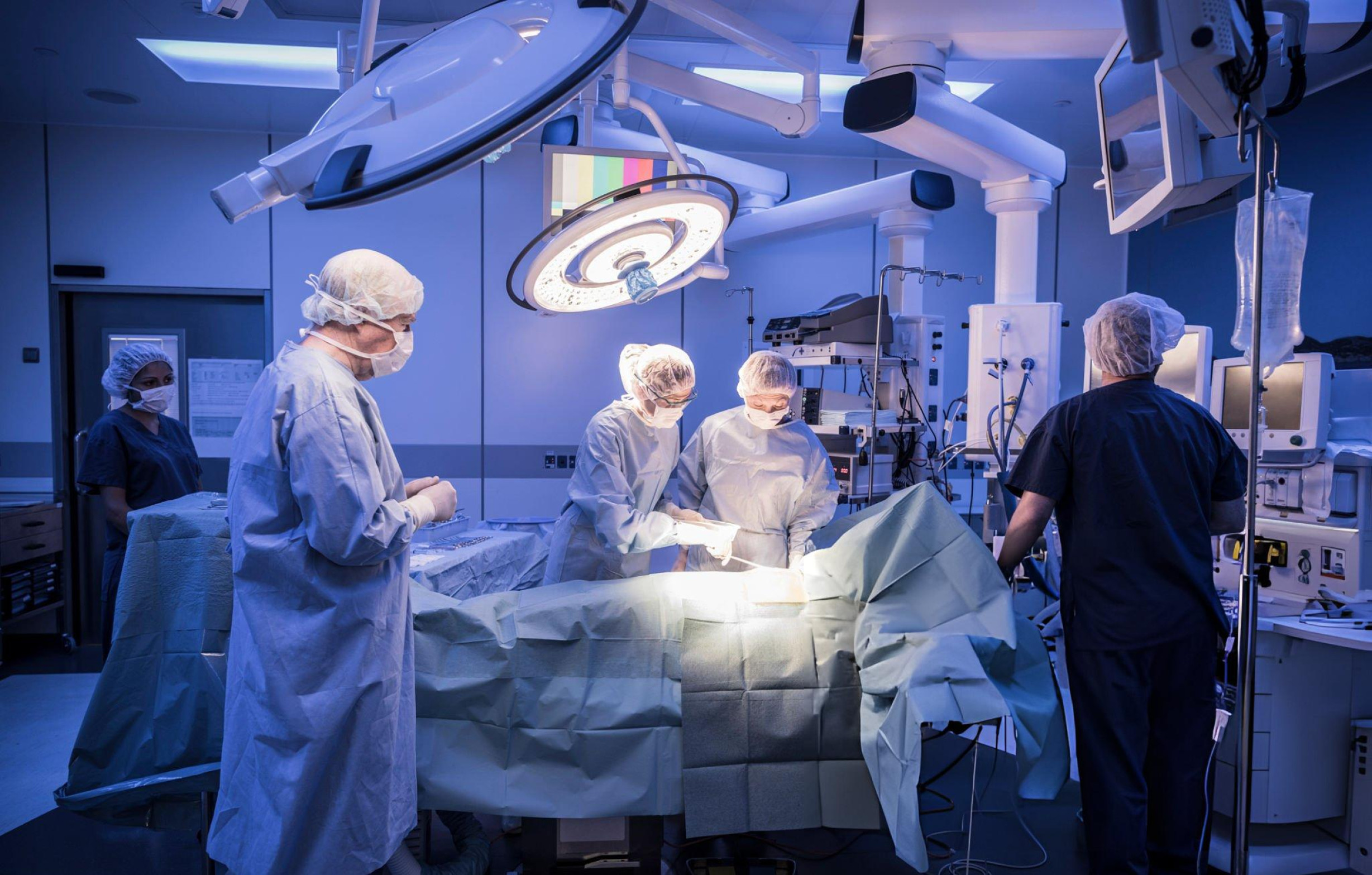 5 doctors performing heart operation in the operating room