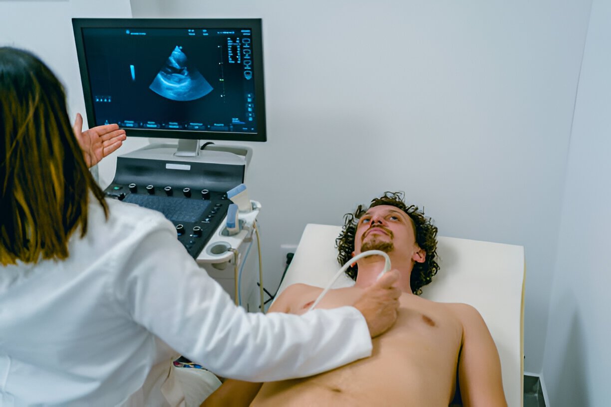 female doctor performing Echocardiography on male patient