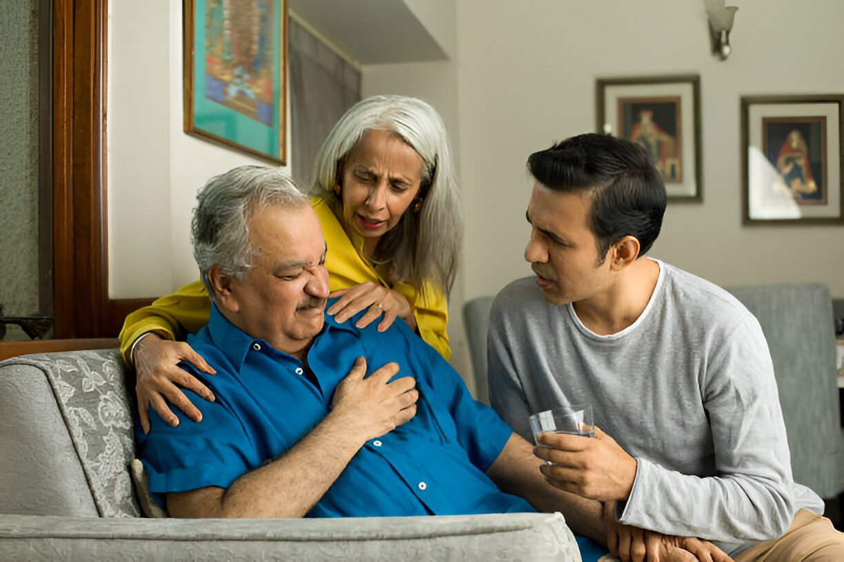 old age person having Angina chest pain with his family member worried around him