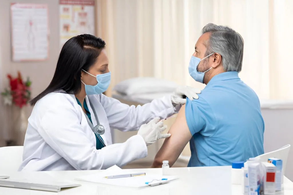 Doctor drawing blood from a patient's arm using a needle