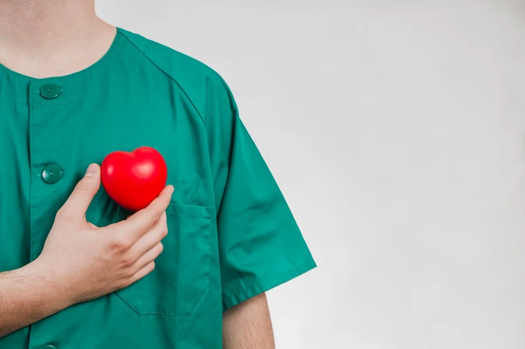 nurse showing plastic heart