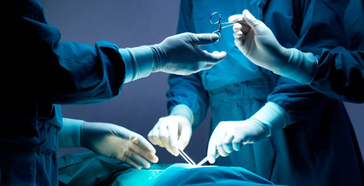 Doctor and nurse medical team are performing surgical operation